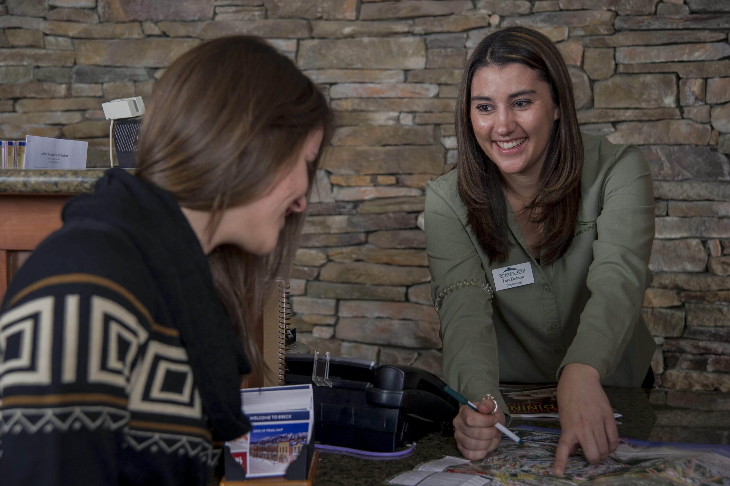 person helping a customer at the concierge desk