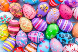 Beautiful colorful easter eggs on blue wooden background. Easter holiday concept.