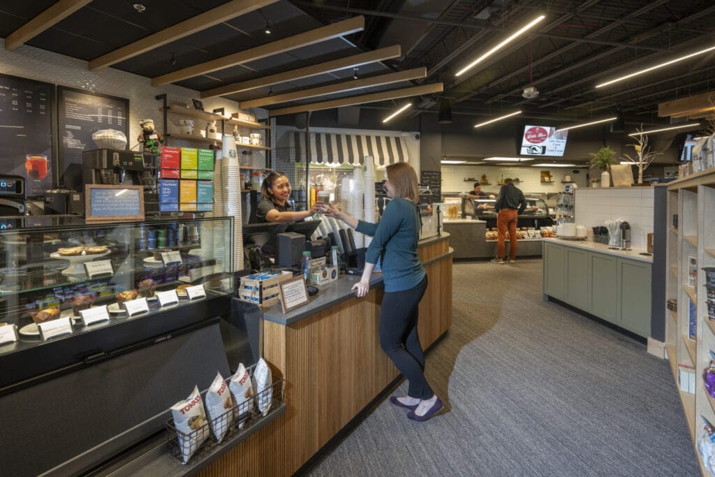 People shopping at the Starbucks counter at the Skywalk market