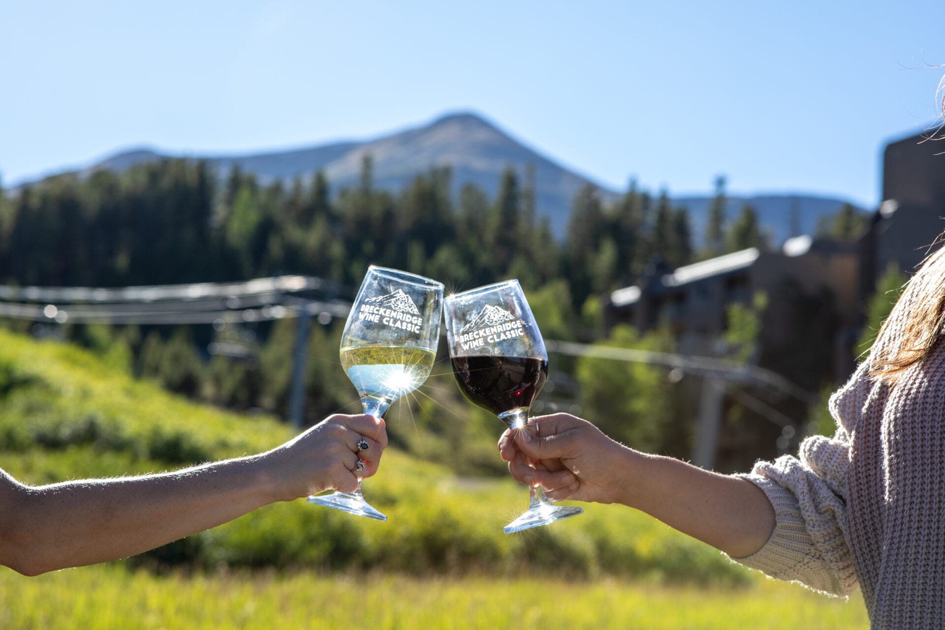 2 glasses of wine being toasted outside in Breckenridge