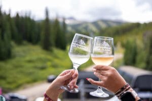 2 glasses of wine being toasted outside in Breckenridge
