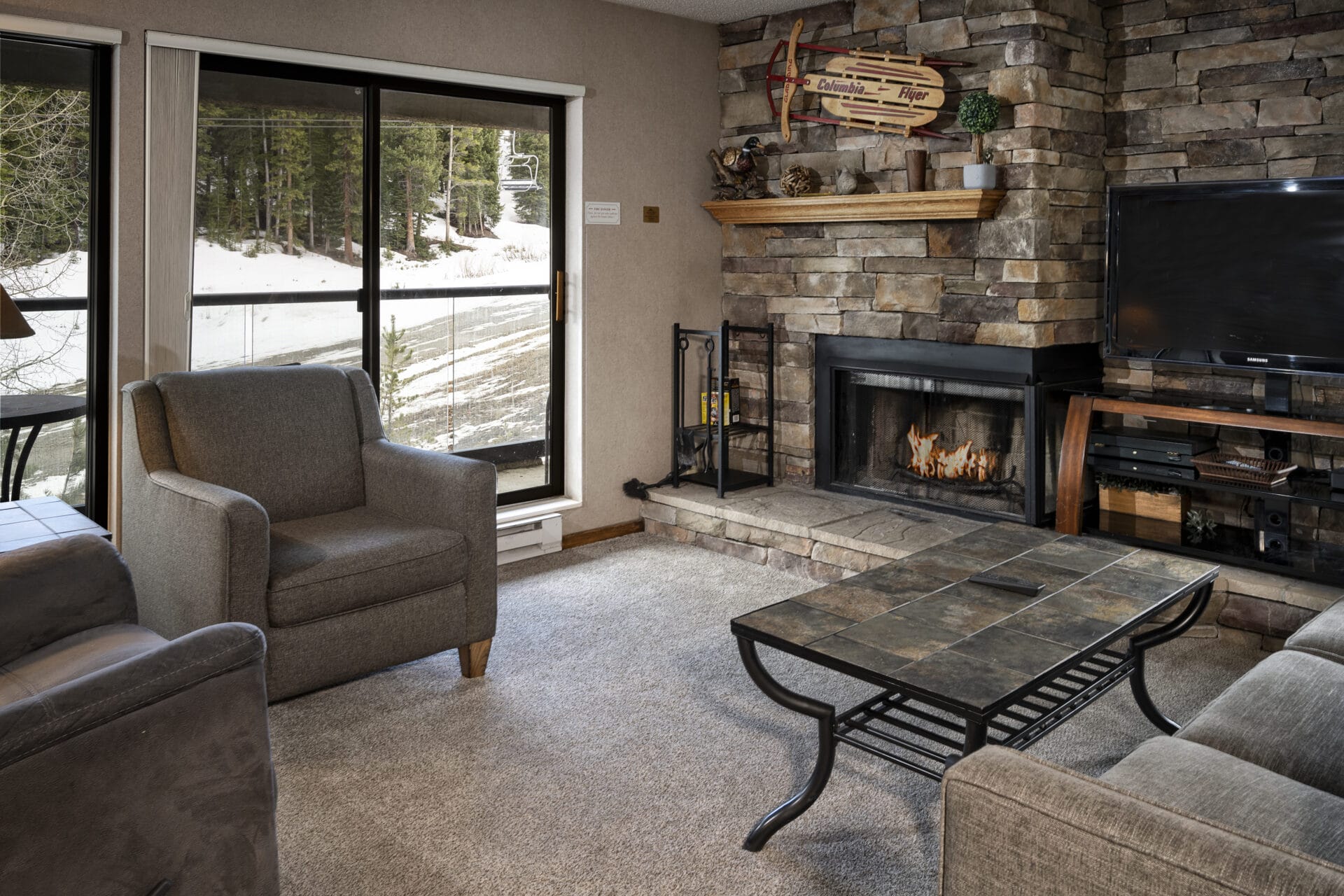 corporate suite living room with fireplace and mountain view