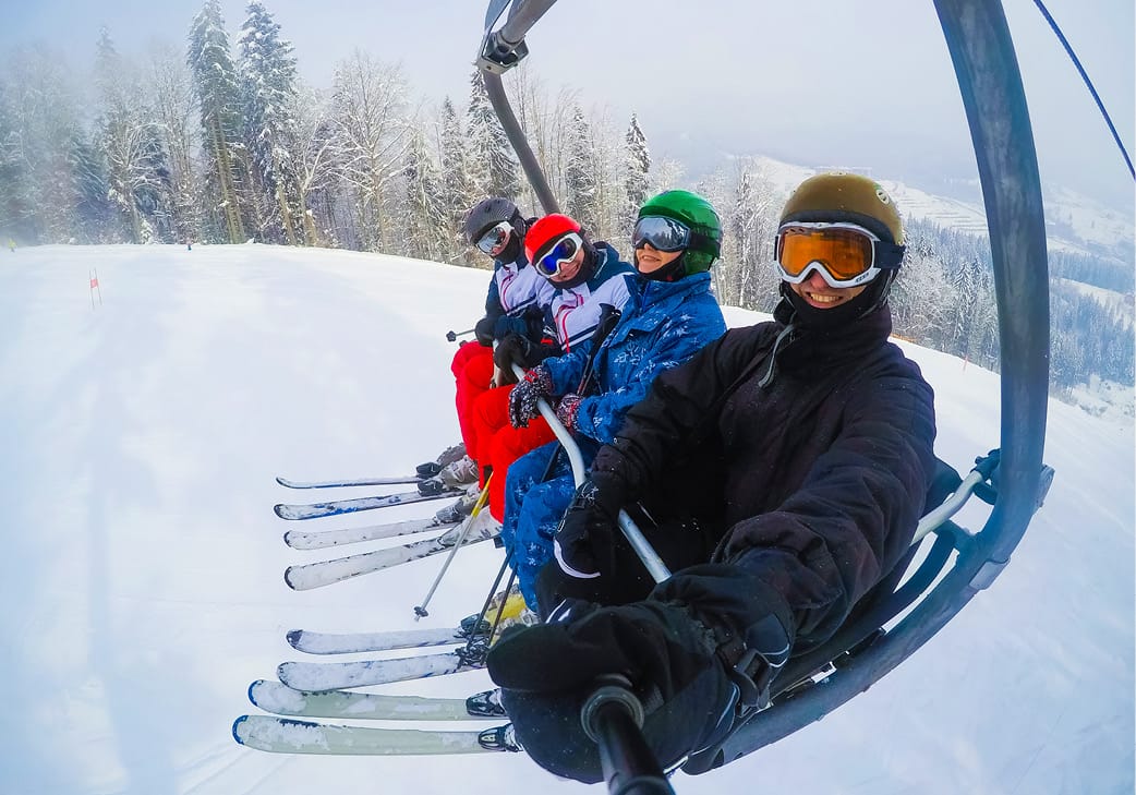 Skiers on ski chairlift