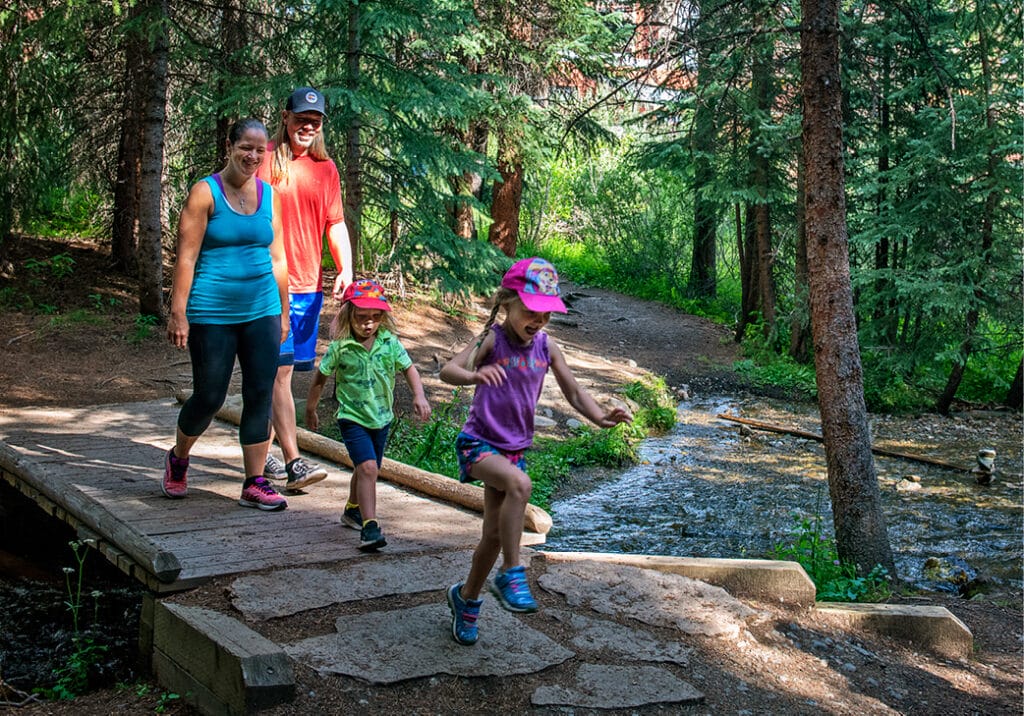 Family walking in woods at Beaver Run Resort