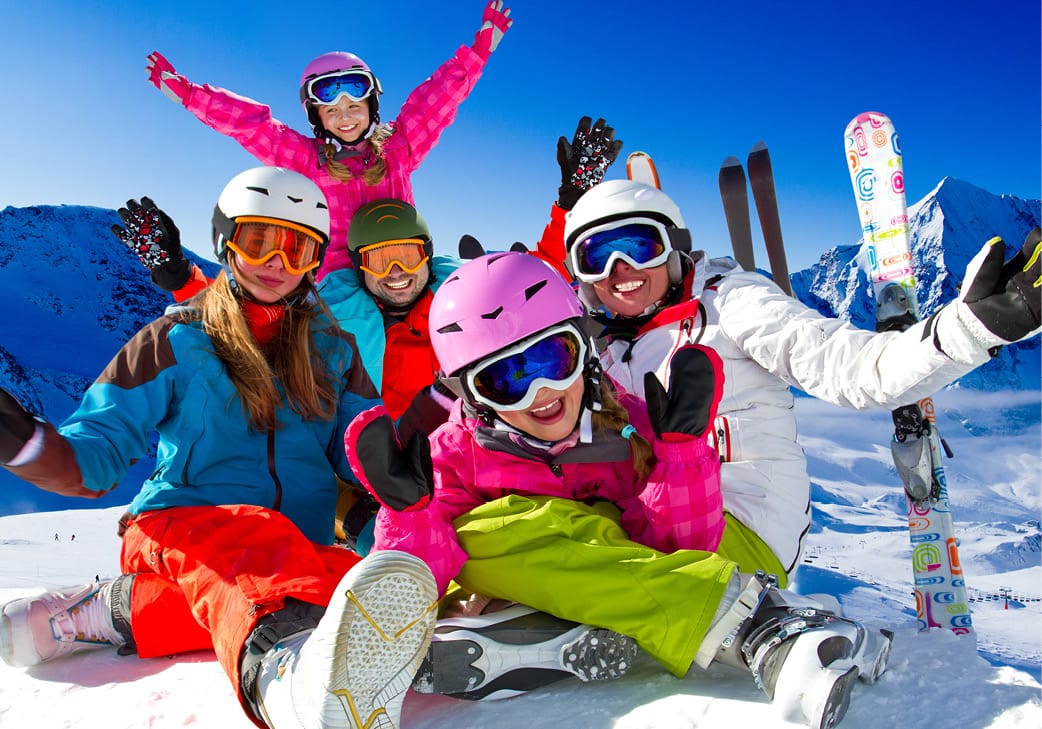 skiers and snowboarders celebrating on the mountain