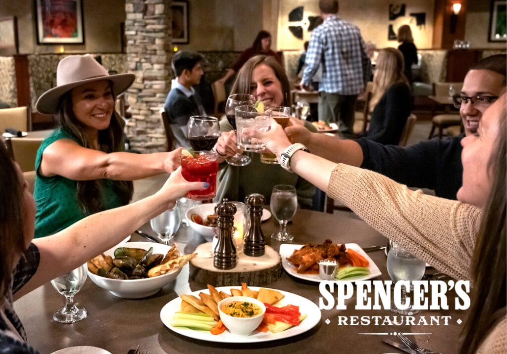 Spencer's Steaks and Spirits people toasting and appetizers