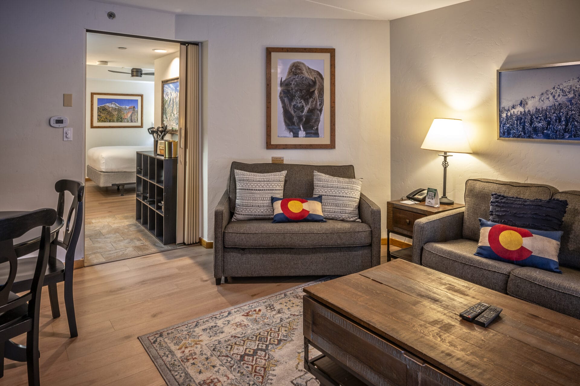 studio living room with bed in background