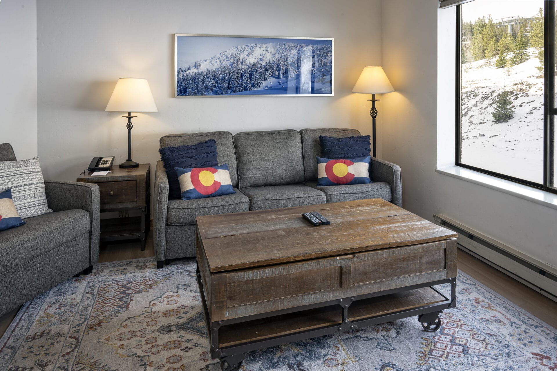 studio living room with couch and pillows and coffee table